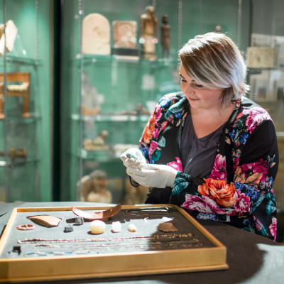 A woman holding artifacts