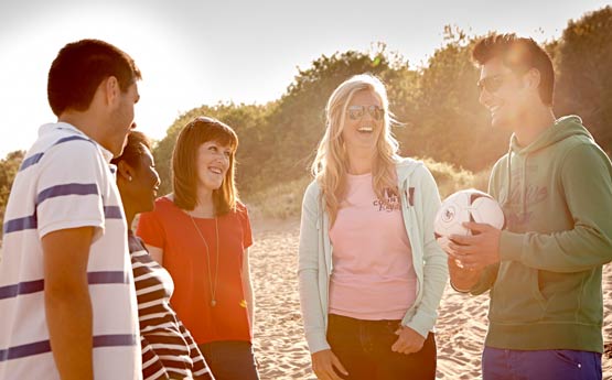 Group of students chatting on the beach