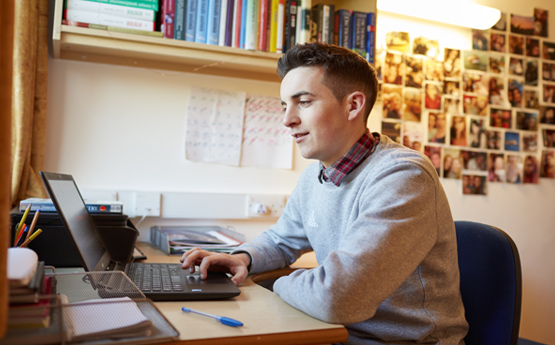 Student in accomodation on a laptop
